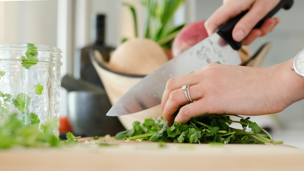 A chef cutting cilantro